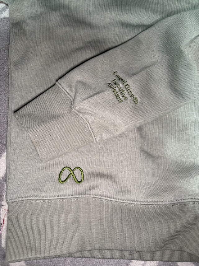 Company sweatshirt with logo and title on forearm